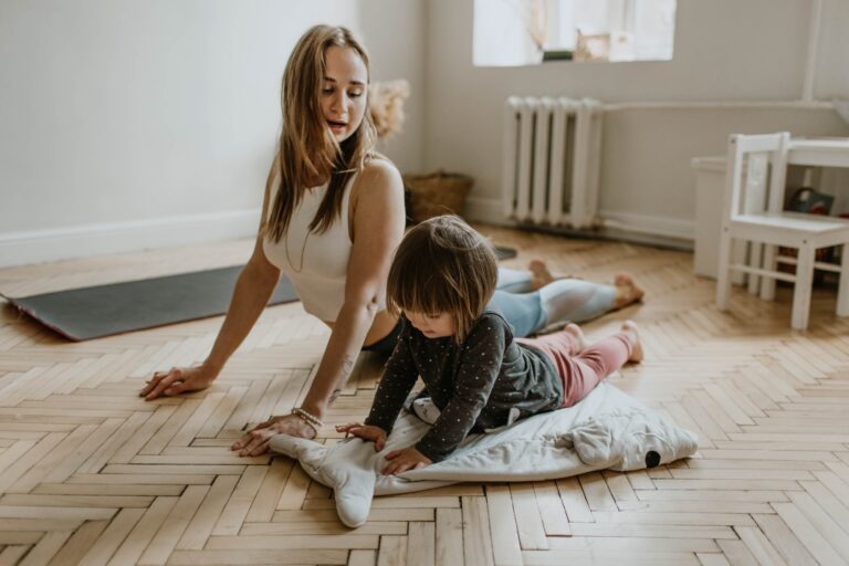 Stay at home mom doing yoga with her child